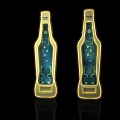 Two Blue Beer Bottle Shaped Bottle Openers With Golden Borders On Black Background