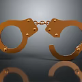 Detailed Golden Handcuffs With Metallic Shiny Finish On Reflective Surface
