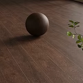 Dark Brown Wooden Floor With Round Decorative Ball And Green Leaf Branch