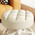 White Round Tufted Stool With Wheels On Striped Rug In Living Room