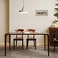 Modern Dining Area With Wooden Table And Chairs Pendant Light Framed Art And Green Plant