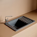Black Kitchen Sink With Built In Drainer And Silver Faucet On Light Brown Countertop