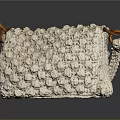 Cream Colored Crocheted Handbag With Textured Surface And Brown Leather Handles