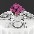 Elegant Dinnerware Set on Round Table with Purple Flower Bouquet and Wine Glasses
