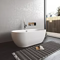 White Freestanding Bathtub in Modern Bathroom with Striped Rug and Mountain View Window