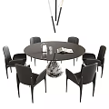 Modern Round Black Dining Table and Chairs Set with Decorative Vase and Magazine