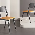Modern Dining Chairs With Black Frame And Orange Seat Cushion In Minimalist Interior