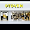 Stylish Clothing Store Interior With Displayed Apparel Clothing Racks And Checkout Counter