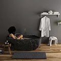 Dark Stone Freestanding Bathtub With Bathrobe On Rack Plants Stool And Wooden Floor Rug