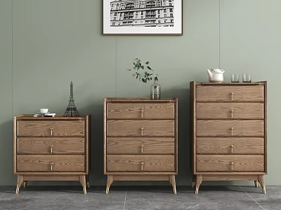 Three Wooden Dressers Against Light Green Wall With Artwork And Decor On Top 3d model