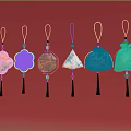 Traditional Colorful Hanging Ornaments With Various Shapes And Tassels On Red Background