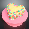 Heart Shaped Cake With Yellow Body And Colorful Heart Decorations On Pink Base