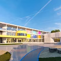 Modern Colorful School Building With Large Glass Windows And Spacious Courtyard