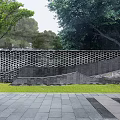 Curved Garden Feature Wall With Perforated Bricks Green Trees And Pink Blossoms