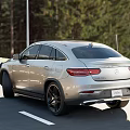 Silver Mercedes Coupe SUV Parked On Road With Scenic Mountain View