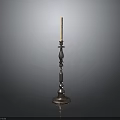 Metal Candle Holder With Decorative Column Base And Lit White Candle On Dark Background