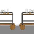 Stylish Serving Trolleys With Wooden Wheels Metal Frames And Glassware Items