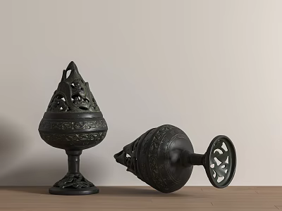 Two Black Incense Burners With Carved Patterns Upright And Tilted On Wooden Tabletop 3d model