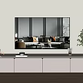 TV Mounted Above Light Gray TV Stand with Decorative Items Books and Potted Plant