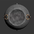 Metallic Cauldron With Three Legs And Brass Handles On Black Reflective Surface