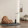 Cloud Shaped Brown Single Sofa With Beige Floor Lamp Small Table And Wooden Floor