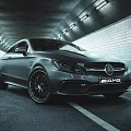 Silver Mercedes AMG Sporty Car Driving Through Illuminated Tunnel On Asphalt Road