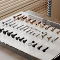 Assorted Metal Hardware Tools Including Screws Bolts And Fasteners On Transparent Display Stand