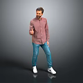 Man in red shirt blue jeans and white sneakers posing on gray background