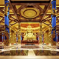 Sacred Buddhist Temple Interior With Golden Buddha Statue Blue Pillars Ornate Ceiling And Marble Floor