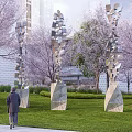 Contemporary Fragmented Metal Sculptures in Park Lawn With Cherry Blossom Trees