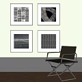 Modern Single Chair With Metal Frame Armrests Against Light Wall And Four Framed Artworks