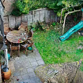 Outdoor Garden Landscape With Wooden Table Chairs Green Slide And Lush Grass