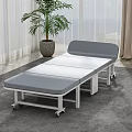 Folding Medical Examination Bed With Gray Mattress White Frame And Wheels In Indoor Setting