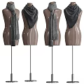 Fashionable Gray Knit Scarves Displayed On Wooden Mannequins With Various Designs