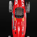 Red Vintage Racing Car With Streamlined Body Large Wheels And Green Roof