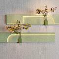Green Glittery Curved Wall Decor With Small Vases Holding Yellow and Red Flowers