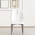 Modern Minimalist White Leather Accent Chair With Silver Metal Legs And Wall Art Decor