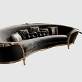 Spacious Luxurious Black Velvet Curved Sofa With Gold Accents Decorative Throw Pillows And Side Table