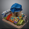 Colorful Rolled Towels Display With Blue Towel In Wooden Basket And Various Patterns On Tray