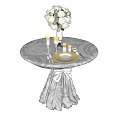Round Coffee Table With Gray Tablecloth Draped Decoration White Flower Bouquet Golden Goblets And Cutlery