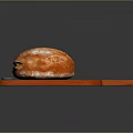 Golden Freshly Baked Artisan Bread On Wooden Cutting Board With Knife