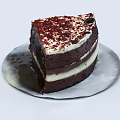 Delicious Layered Chocolate Cake With Cream Red Crumbs And Chocolate Chips On Patterned Plate