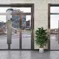 Modern Glass Entrance Doors With Metal Frames And Potted Plant Near Urban Buildings