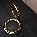 Polished Golden Bracelets Displayed On Dark Surface With Wooden Background