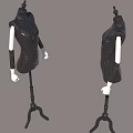 Two Black Mannequins Wearing Sequined Dresses With White Arms On Stands