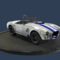 White Convertible Sports Car With Blue Racing Stripes On Black Circular Display Platform