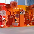 Luxury Life Themed Display With Red Backdrop And Orange White Decorative Flowers