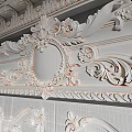 Elegant White Double Doors With Carved Patterns Golden Handle And Ornate Wall Panels
