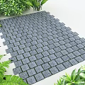 Gray Brick Pavement Surrounded By Lush Green Plants In Garden Area
