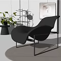 Modern Black Leather Lounge Chair With Metal Frame Artwork And Green Plant In Stylish Interior